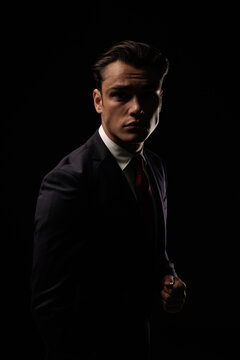 Confident elegant man standing and looking forward