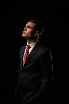 Ambitious formal man standing and looking up