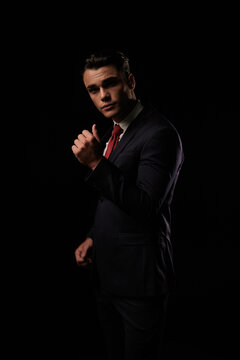 Serious man posing in suit and looking forward