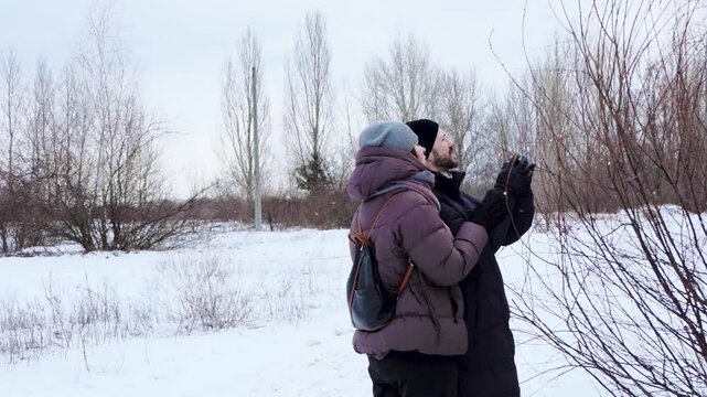 Young Couple Exploring Nature Together in Winter Park Outdoors