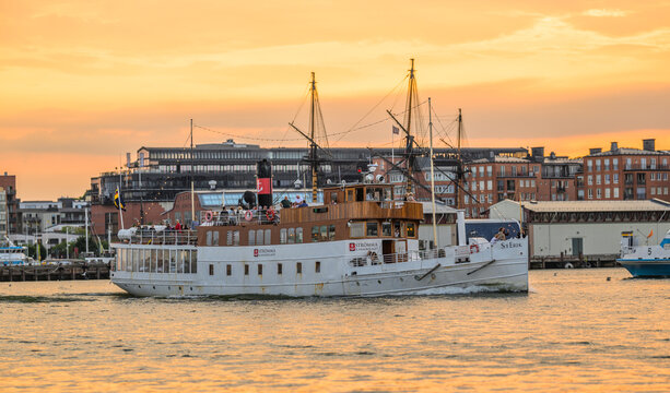 Gothenburg, Sweden - July 29 2026: Historic St Erik passenger boat cruising Gothenburg harbor at sunset.