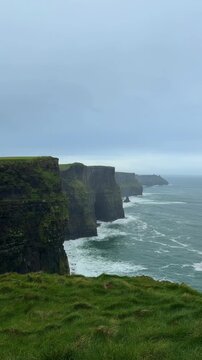 Scenic View of Cliffs of Moher and Atlantic Ocean under Cloudy Sky in Ireland