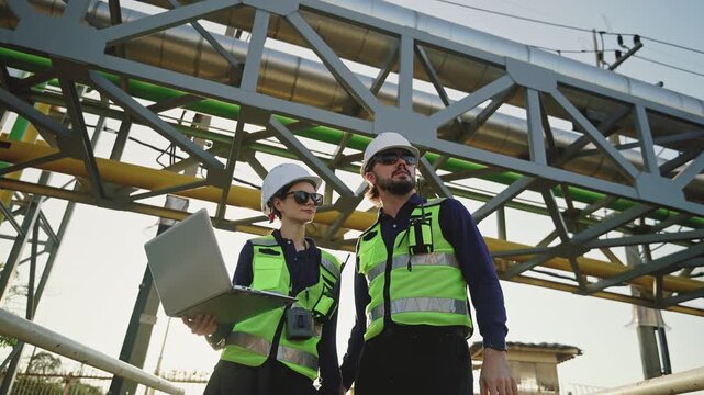 Industrial engineers inspecting an oil and gas refinery, reviewing plant operations and discussing maintenance, safety and energy infrastructure, refinery plant industry factory, Petrochemical plant.