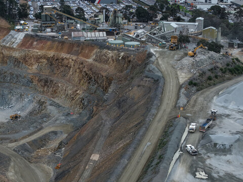 Montrose, Australia - 28 August 2026: Aerial view of the Boral Montrose quarry showing industrial mining operations, heavy machinery, gravel stockpiles, and excavated rock faces.