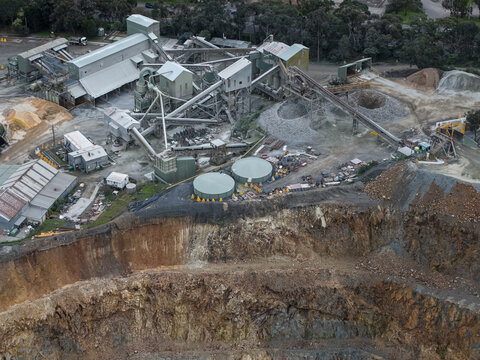 Montrose, Victoria, Australia - 28 August 2026: Aerial view of Boral Montrose quarry featuring industrial processing facilities, conveyor belts, storage tanks, and deep rock excavation pits.