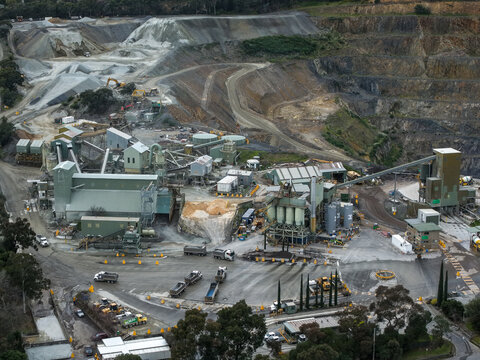 Montrose, Victoria, Australia - 28 August 2026: Aerial view of Boral Montrose quarry featuring industrial processing facilities, heavy machinery, trucks, and excavated rock faces.