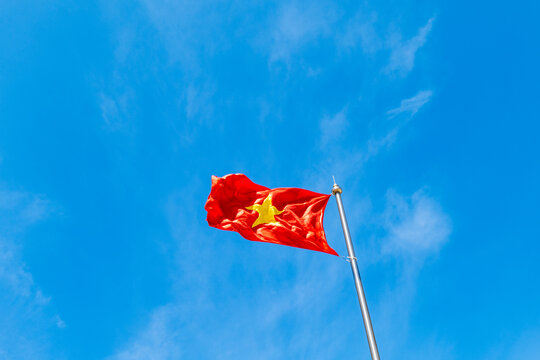 Vietnamese flag waving again the blue sky background in Vietnam