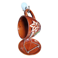 Brown ceramic tea cup and saucer on a metal display stand
