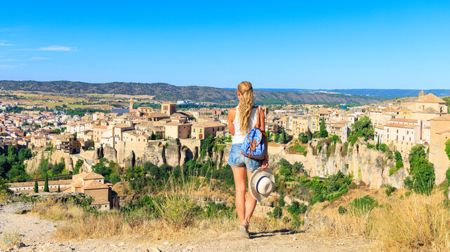 Woman tourist enjoying panoramic view of Cuenca hanging houses in Spain