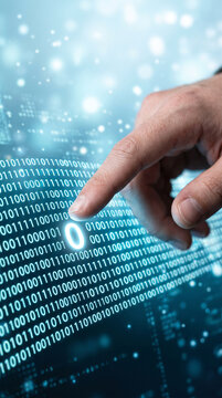 Human finger interacting with glowing binary code on a digital screen, symbolizing data, technology, and digital interaction.