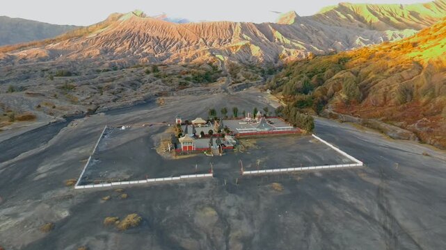 Aerial view of Pura Luhur Poten temple situated in the vast volcanic sand sea at the base of Mount Bromo in Kecamatan Sukapura, Jawa Timur, Indonesia.