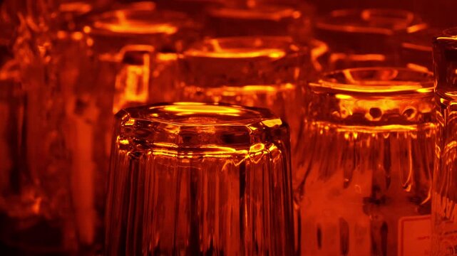 Empty Glassware Rows Bathed in Warm Amber Bar Light, Moody Nightlife Ambiance