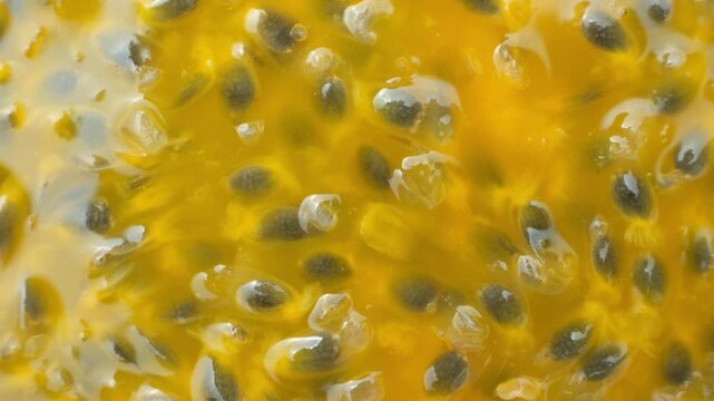 Abstract rotation of juicy passionfruit pulp background top view