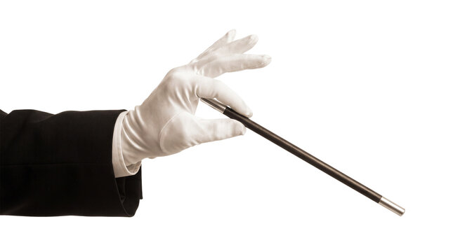 Magician Hand in White Glove Holding Magic Wand Isolated on Black Background, Illusionist Performing Magic Trick or Casting Spell