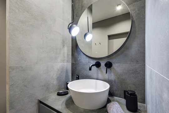  details of corner with water tap sink with faucet with soap and shampoo dispensers in expensive bathroom in rustic eco style