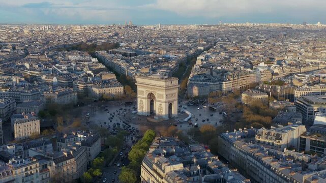 Aerial view of the Arc de Triomphe at the center of the Place Charles de Gaulle surrounded by historic Parisian architecture and radiating avenues in Paris, Ile-de-France, France.