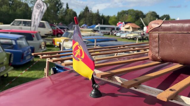 Old GDR Flag Fluttering on a Car in the Wind &ndash; Symbolic Image 4k
