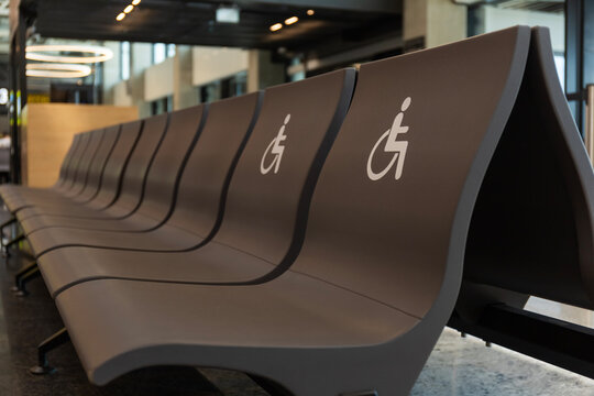 Disabled sign chairs in first row at airport waiting area