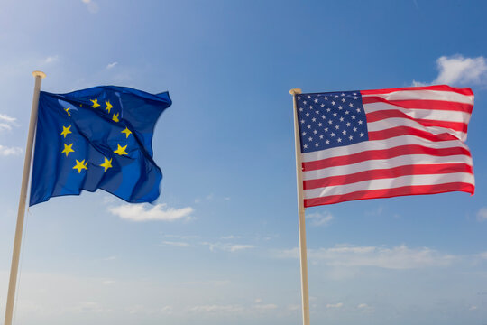 Flags of Europe Union and United States of America next to each other in the sky - EU and USA