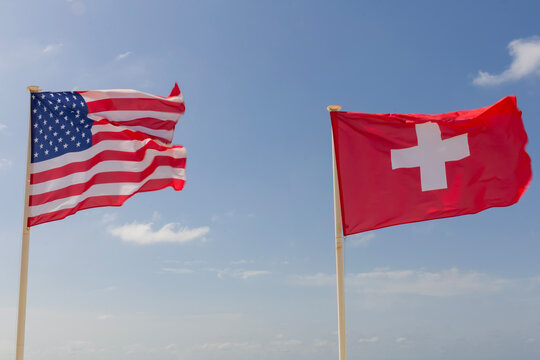 Flags of the USA nited States of Americaand Switzerland next to each other in the sky