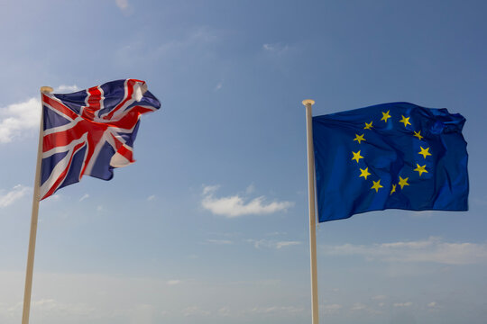 Flags of the United Kingdom and the European Union against a blue sky
