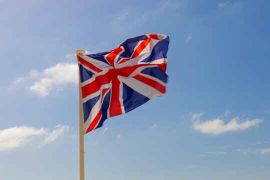 Flag of the United Kingdom against a blue sky