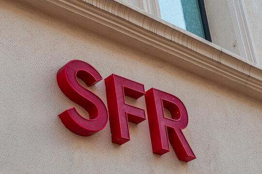 Cannes, France - August 02, 2026: Red three-dimensional SFR company sign mounted on the exterior wall of a building