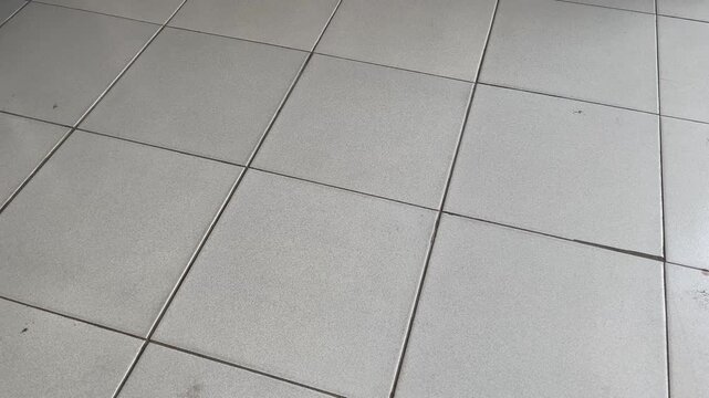 Clean white ceramic floor tiles texture background with grey grout lines