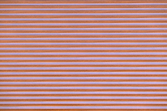 Alternating horizontal stripes of brown wood grain and light purple creating a textured background and repeating linear pattern