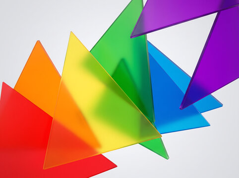 Vibrant translucent triangles in rainbow colors arranged dynamically on a white background for graphic design.