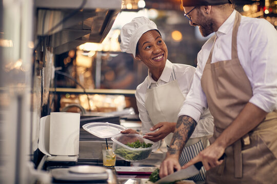 Staff helping chef with prasley. Cook in Professional Modern  kitchen, restaurant concept
