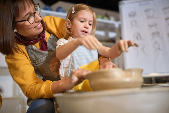 creative pupil girl shaping pot from clay on a pottery workshop.  Creative, hobby ,workshop  concept