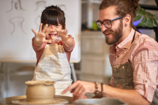 Kid showing Dirty hands on Pottery workshop.  Creative, hobby ,workshop  concept