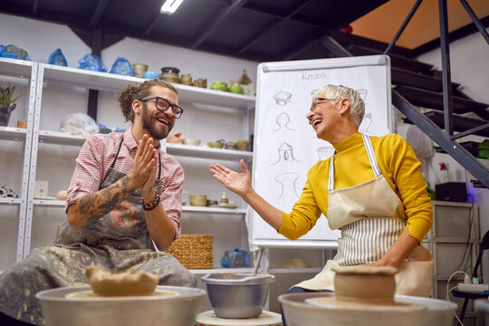 studnets Having fun on pottery workshop class white making bowl from clay.   Creative, hobby ,workshop  concept