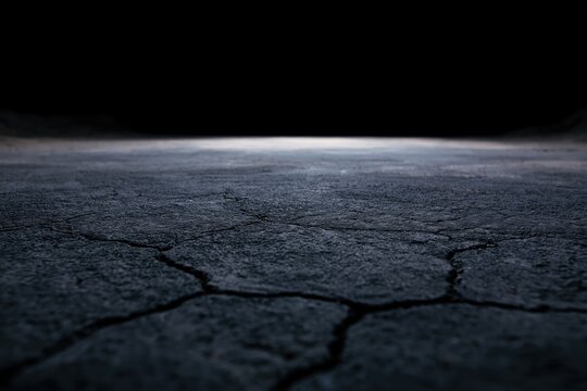 The Cracked Ground Beneath a Narrow Sliver of Light on the Horizon