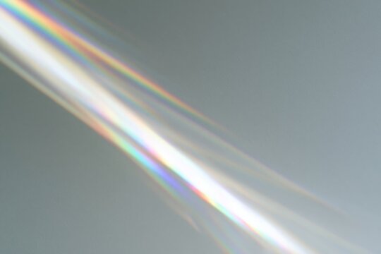 The Rainbow Light Beam Across a Minimalist Grey Background in Sharp Focus