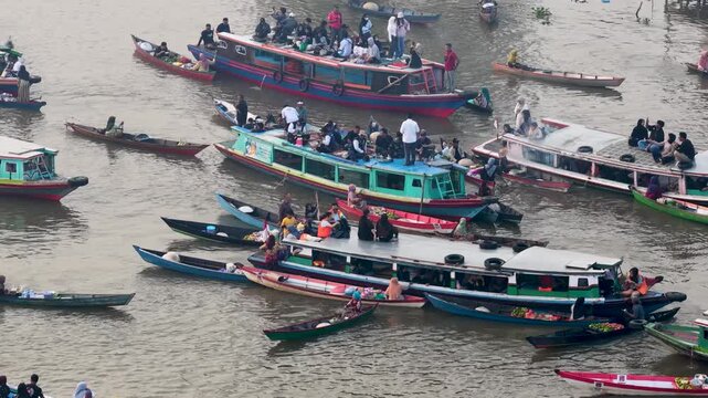 People trade goods from small boats on the river at Lok Baintan Floating Market in South Kalimantan