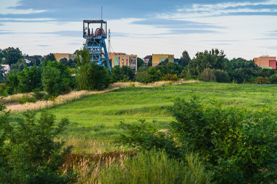 Jaworzno, Poland - 30 August 2026: View of the historic mine headframe rising above the green fields and urban landscape in Jaworzno.