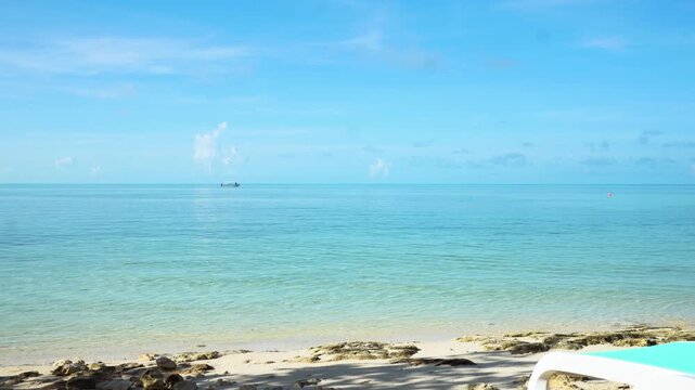 Beautiful tropical Bahamas beach scene with vibrant turquoise ocean water under a vast blue sky