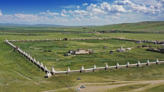 Aerial view of the historic Erdene Zuu Monastery surrounded by white stupas and vast green plains in Kharkhorin, Ovorkhangai, Mongolia.
