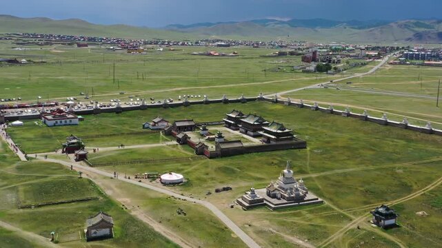 Aerial view of Erdene Zuu Monastery, an ancient Buddhist complex with traditional stupas and temple buildings surrounded by green grasslands in Kharkhorin, Ovorkhangai, Mongolia.