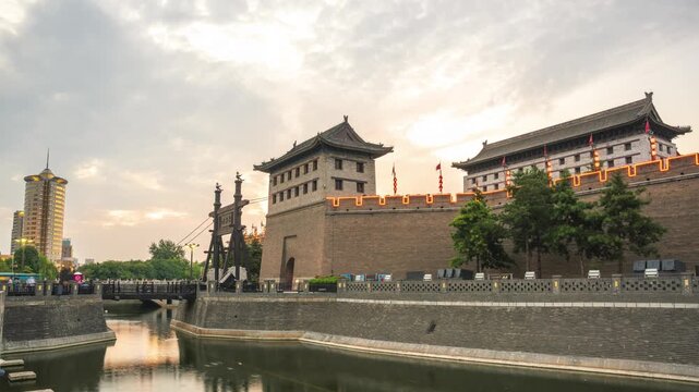 Sunrise over ancient Chinese city walls and river in Xi an, China
