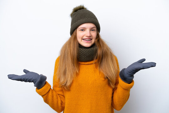 Teenager Russian girl wearing winter jacket isolated on white background with shocked facial expression