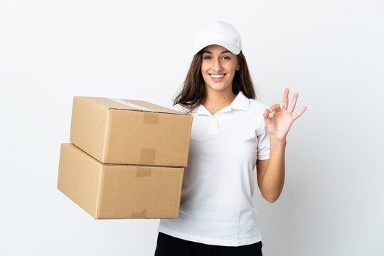 Young delivery woman over isolated white background showing ok sign with two hands