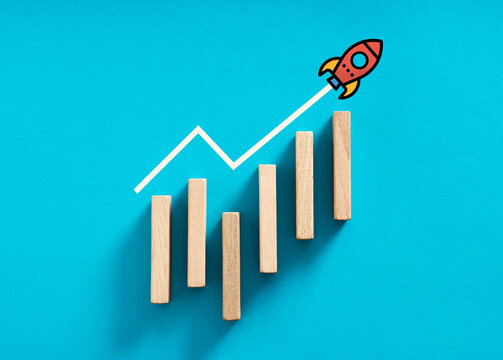 Rising bar chart with a rocket taking off, successful startup, business growth and success