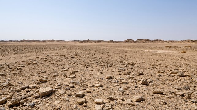 The Desert Landscape Under Clear Sky with Rocky Plain and Distant Dunes