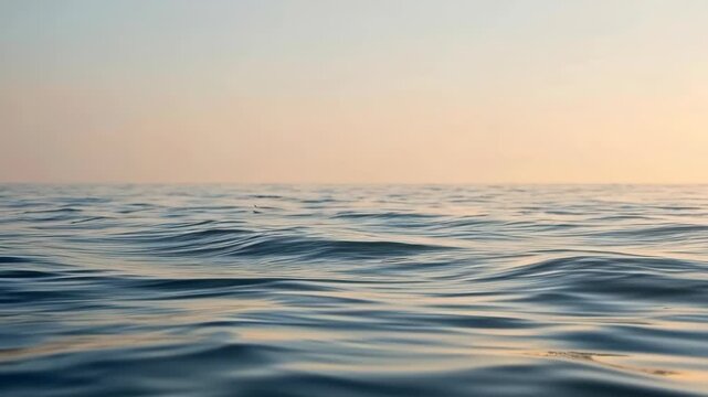Ocean Water Wave at Sunset with Calm Ripple Patterns and Warm Golden Horizon Light