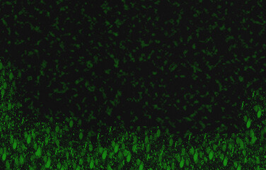 Green fluorescent cells under microscope in biological tissue research laboratory