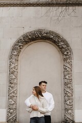 Couple laughing together beside a park fence, with balanced...