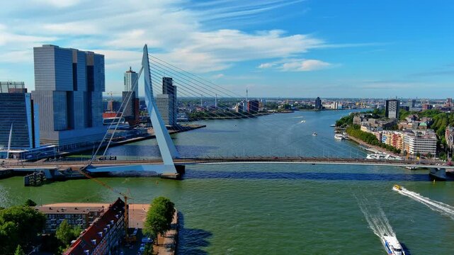 Aerial view of the Erasmus Bridge over the Nieuwe Maas river with Kop van Zuid towers and the port on the horizon, Rotterdam, Netherlands